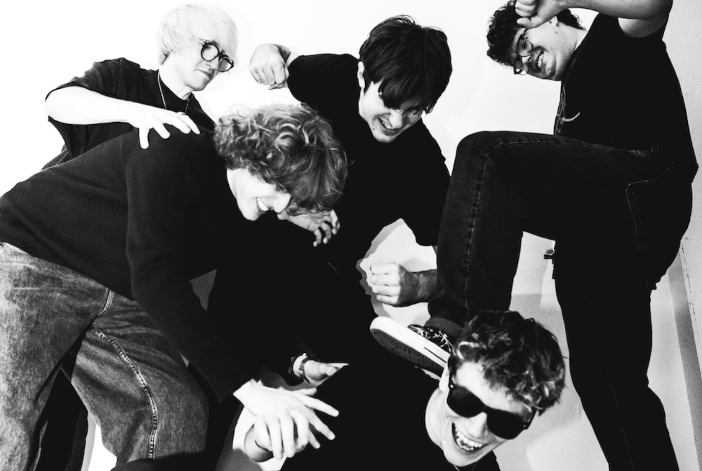 Dylan Winters & The Posterity members pretending to stamp on one of the other members